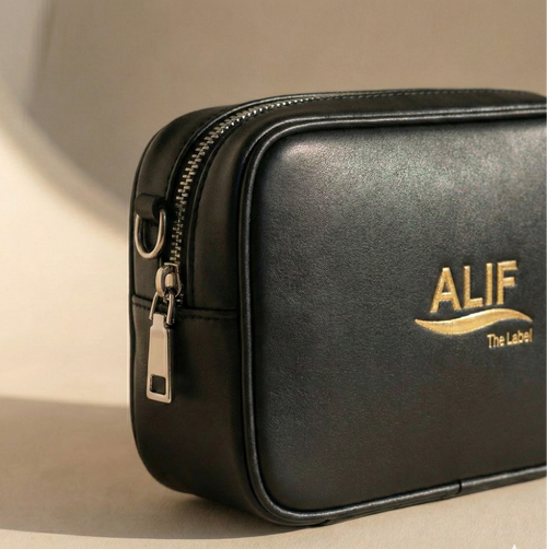 Black leather pouch with 'ALIF The Label' logo on a beige background