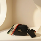 Black Downtown sling with colorful strap and 'ALIF' branding on a white surface.