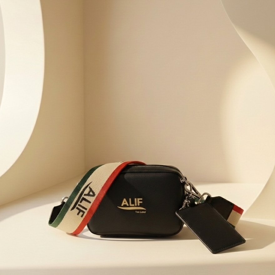 Black Downtown sling with colorful strap and 'ALIF' branding on a white surface.
