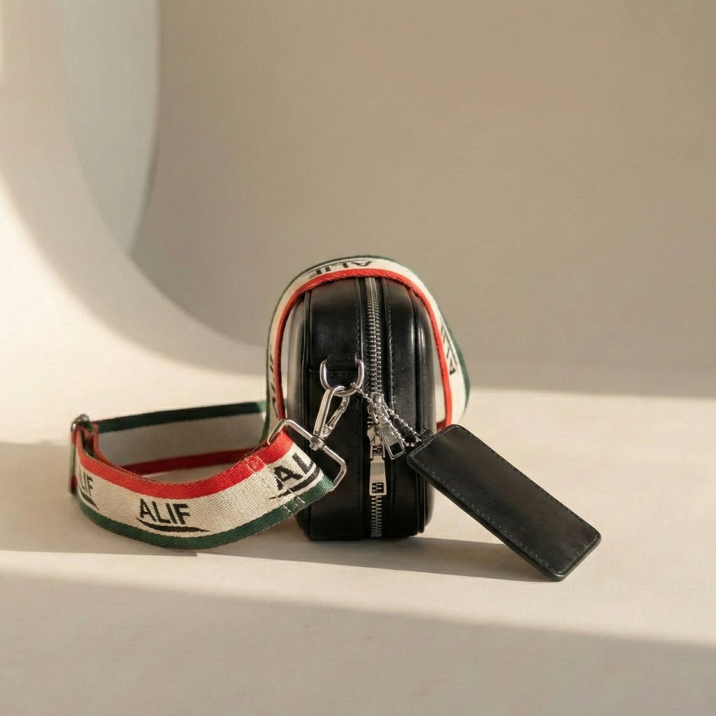 Black zippered pouch with colorful strap and 'ALIFE' branding on a light background