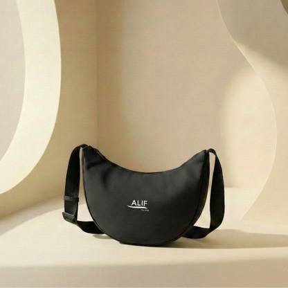 Black bag with 'ALIF' branding on a beige background