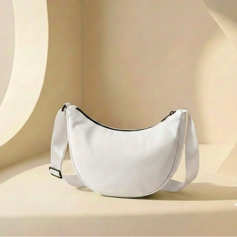 White crescent-shaped bag on a beige background