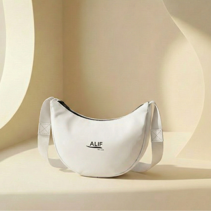 White bag with 'ALIF' branding on a beige background