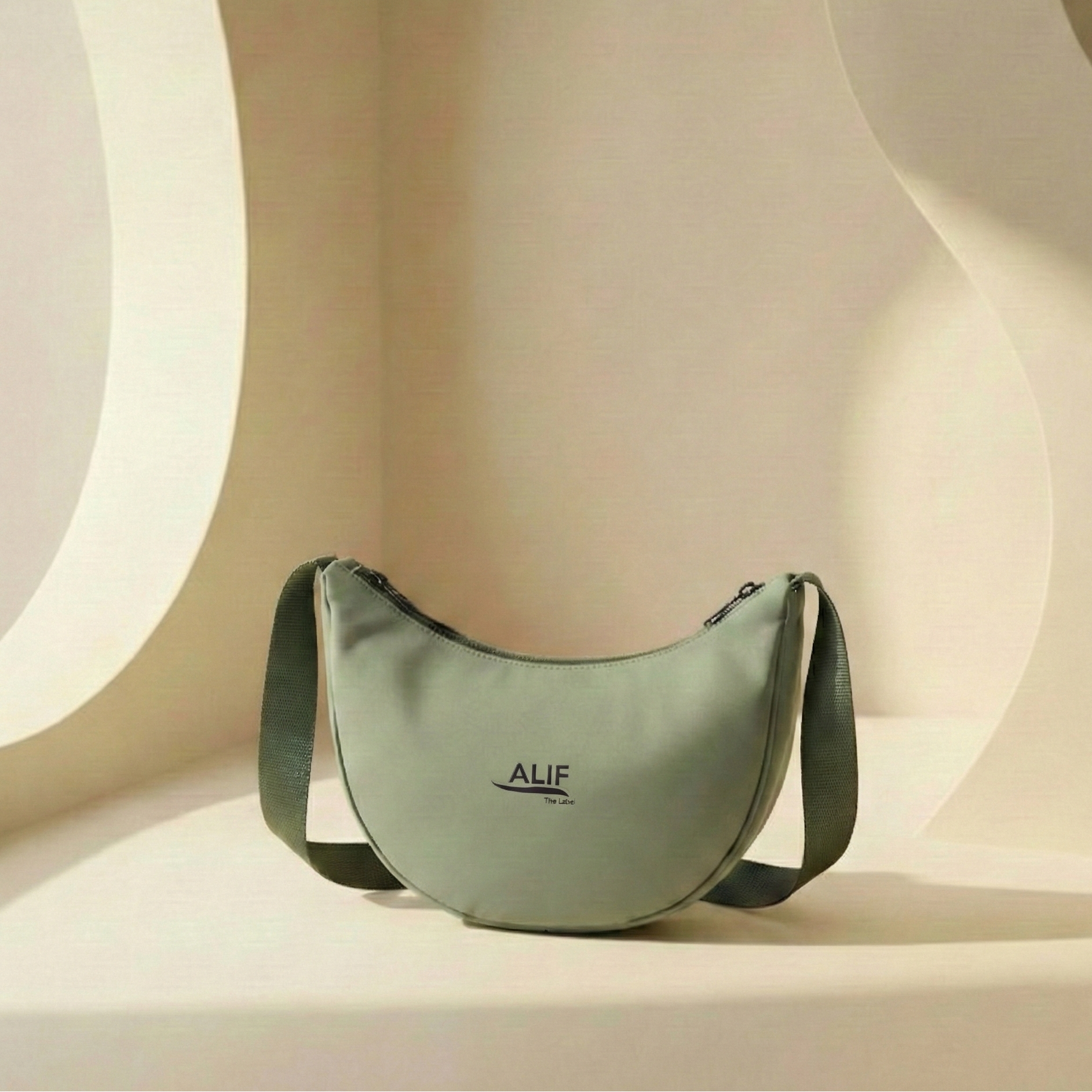 Green handbag with 'ALIF' branding on a beige background