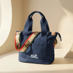 Navy tote bag with a Alif branded strap featuring 'ALIF' branding on a beige background.