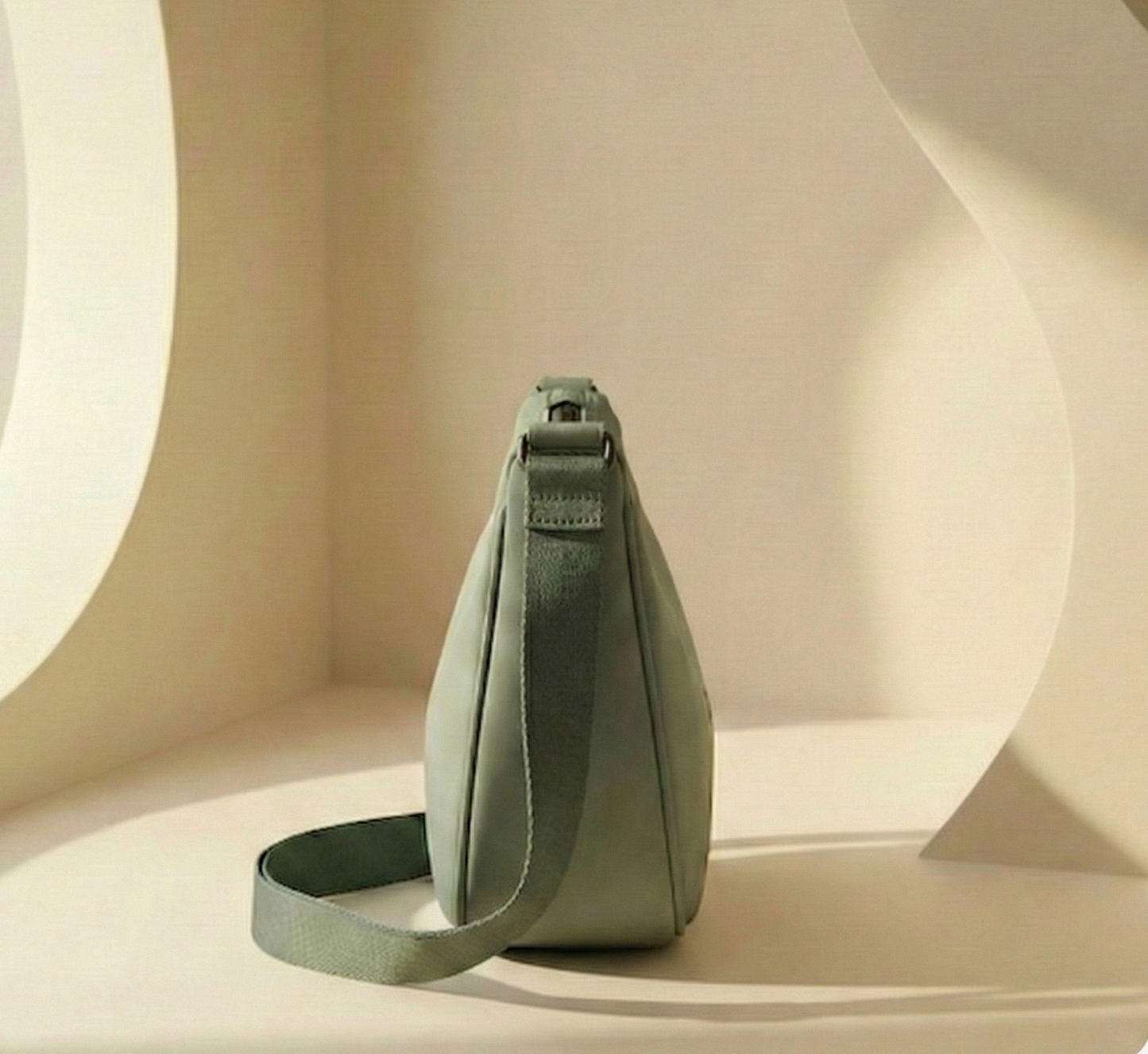 Green shoulder bag on a beige background