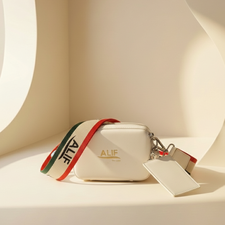 White downtown sling with colorful strap and 'ALIF' branding on a neutral background