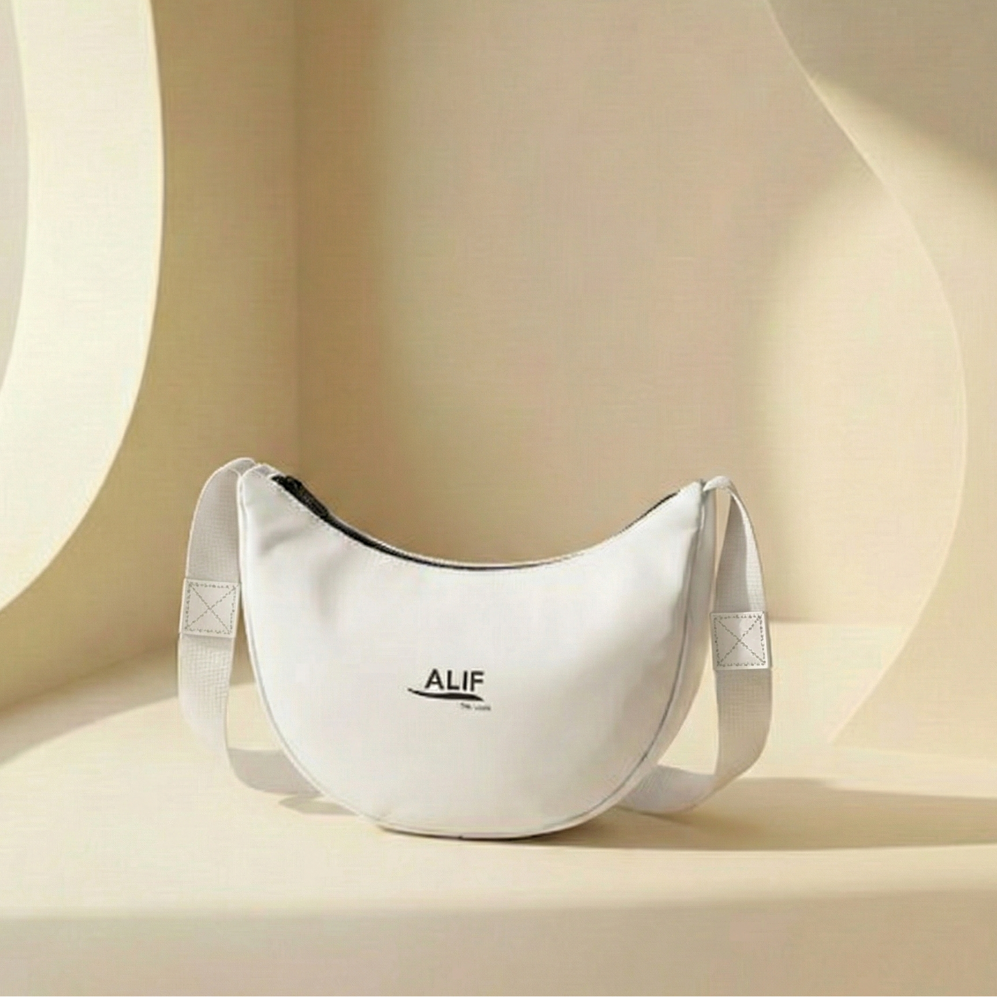 White bag with 'ALIF' branding on a beige background
